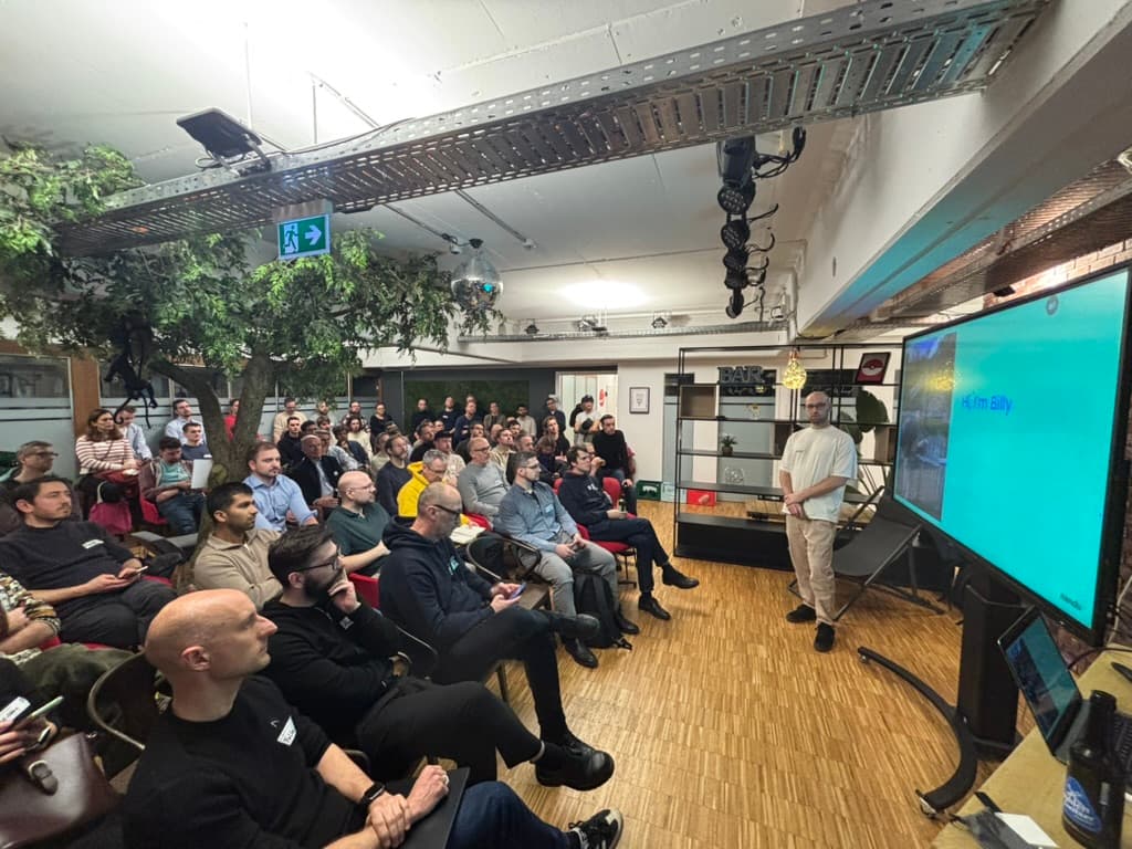 Nandu presenting to a large audience at a tech event