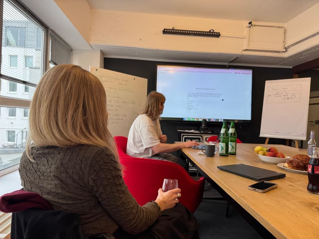 Nandu AI workshop — team working together in a meeting room with screen and whiteboard